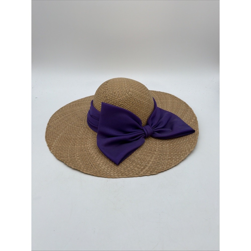 wide-brim woven straw sun hat featuring a vibrant purple fabric band